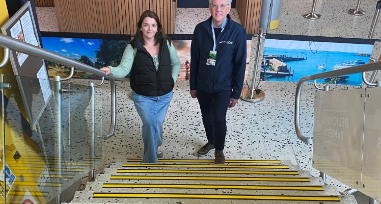 Chantelle Tucker from the Guernsey Blind Association and Mal Mechem from Guernsey Airport by the main staircase. Yellow edge strips have been fitted to all steps on the staircase to help people identify the difference in depth from one step to another.